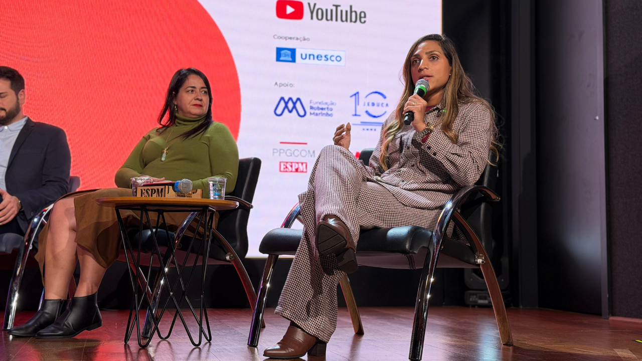 A presidente da MultiRio, Angelina Moreira, fala ao microfone durante painel sobre os desafios da curricularização da educação midiática no 4º Encontro Internacional de Educação Midiática, em São Paulo.